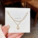 Gold Pearl Double Layer Necklace with Elegant Pearl Drop Pendant and Layered Chain Design